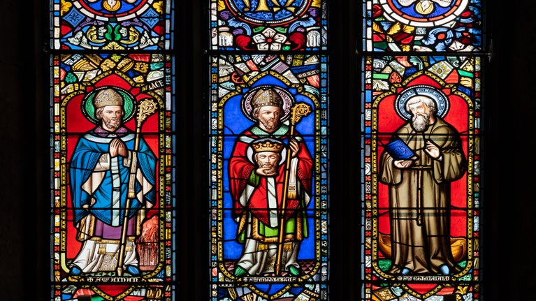 Three saints featured in the stained glass window in St Cuthbert's Chapel, Inner Farne.
